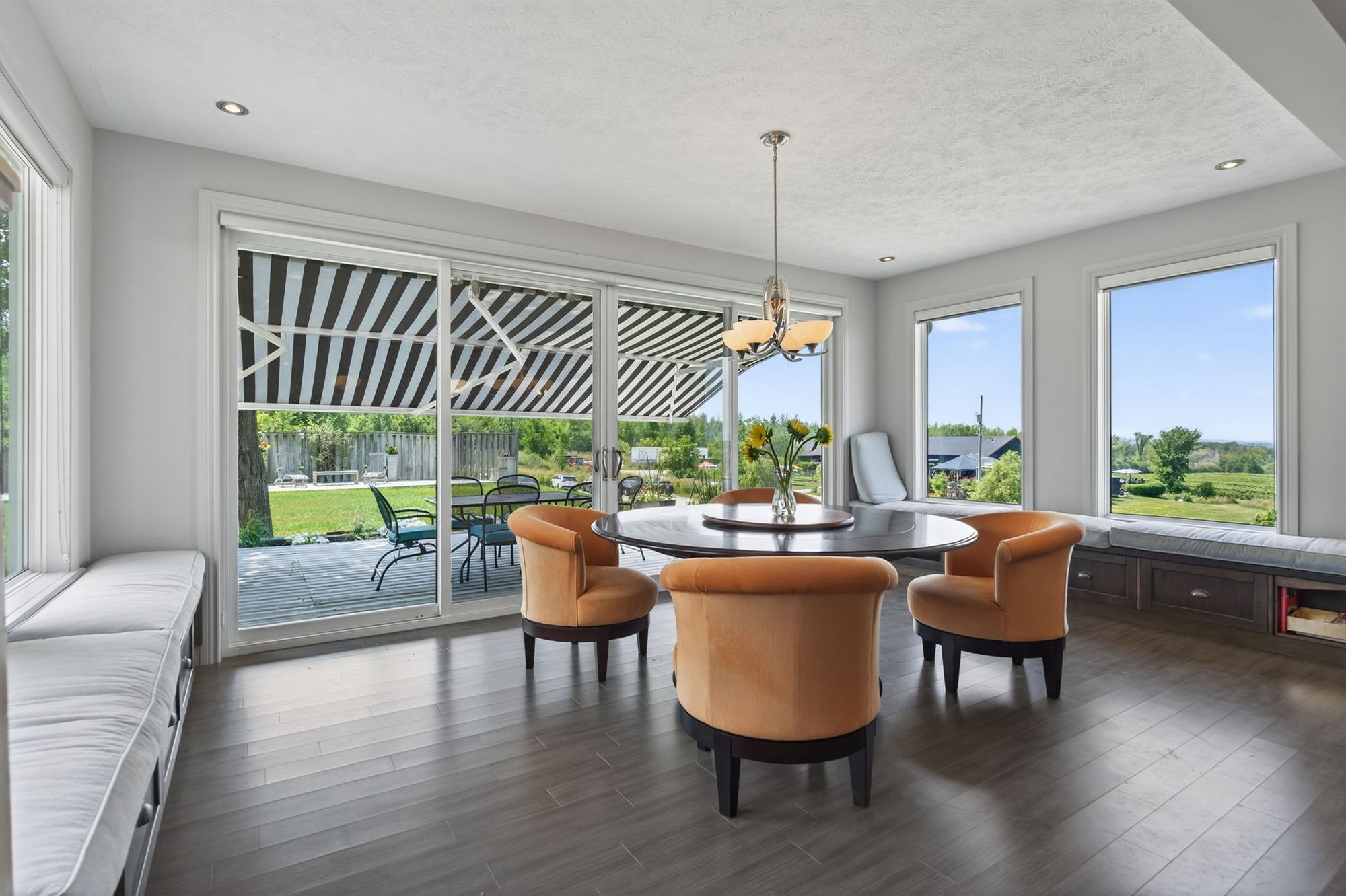 The breakfast room with its round table and the deck beyond