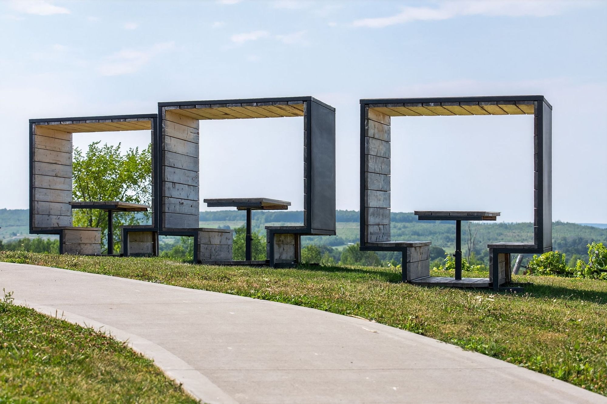 The timber frame seats along the path on the ridge