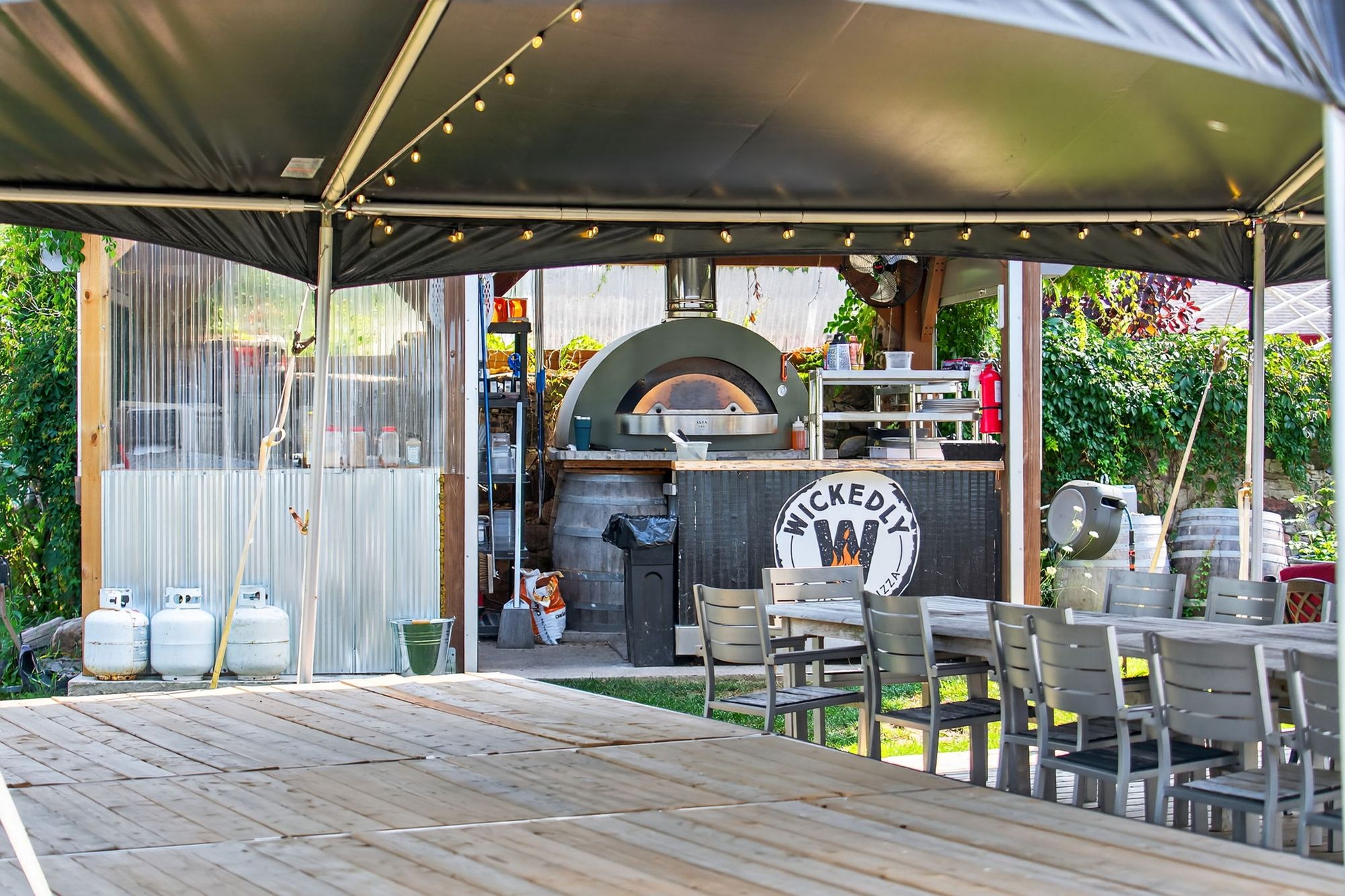 The wood-fired pizza oven under the tent