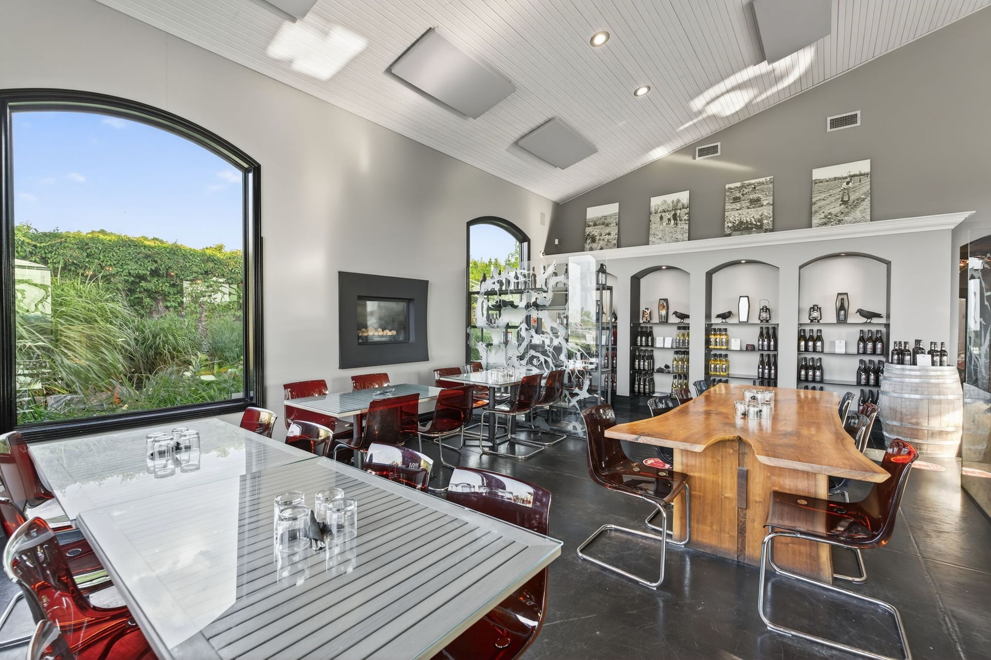 Tables in the tasting room beside the arched windows
