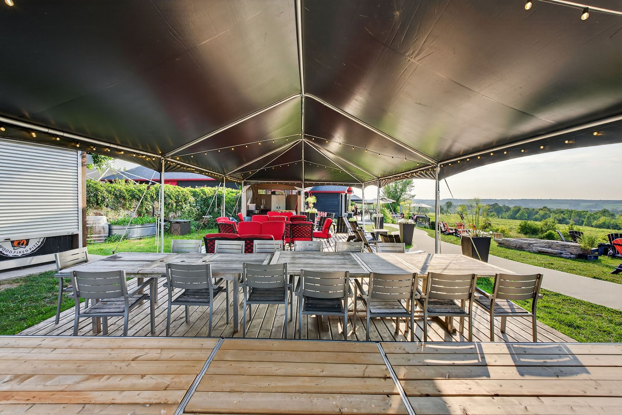 Long tables under the event tent beside the lawn